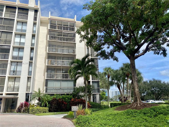 Front view of a multi-story apartment building with balconies.
