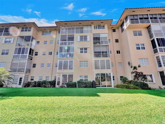 Front view of a multi-story residential building with balconies.