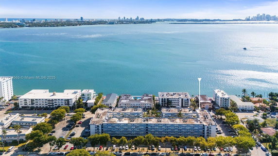 Aerial view of a coastal area with multiple buildings and the ocean in the background.