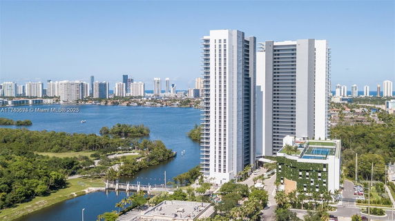 Tall residential buildings with panoramic view of surrounding waterway and cityscape.
