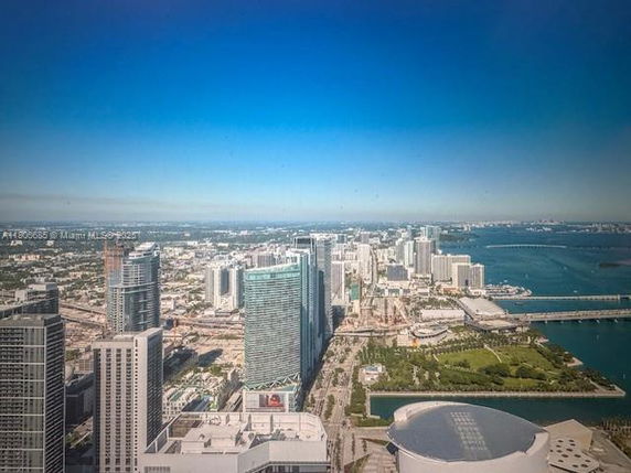 Panoramic view of a city skyline with tall buildings and a waterfront.