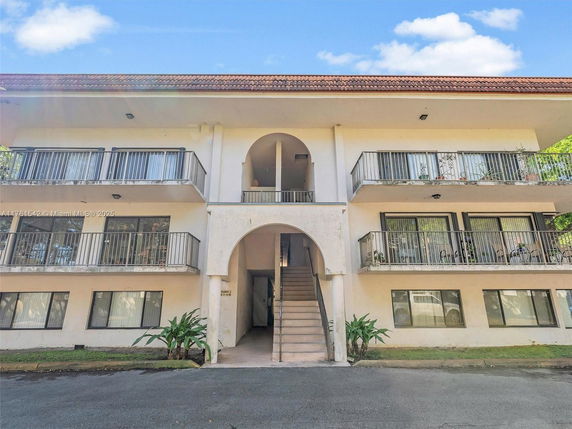 Front view of a three-story residential building with balconies.