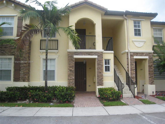 Front view of a two-story house with stone accents and a covered entryway.