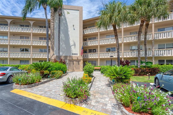Front view of a multi-story apartment building with balconies.