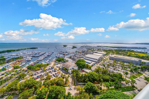 Panoramic view of a marina and surrounding areas with numerous boats and buildings.