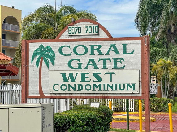 Signage of Coral Gate West Condominium in front of the building exterior.