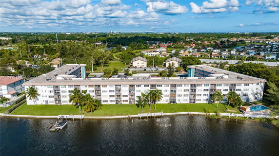 View of a large multi-story residential building near a body of water.