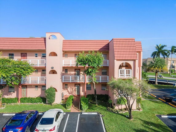 Front view of a multi-story residential building with balconies.