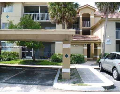 Front view of a multi-story apartment building with balconies.