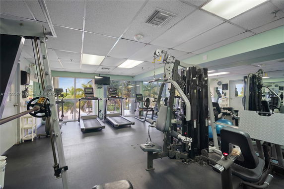 Interior view of a gym with exercise equipment and treadmills.