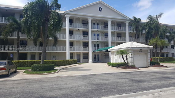 Front view of a multi-story building with columns and balconies.