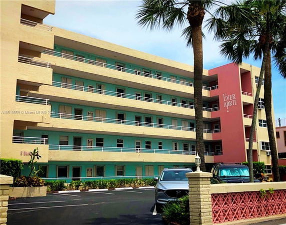 Front view of a multi-story building with balconies.