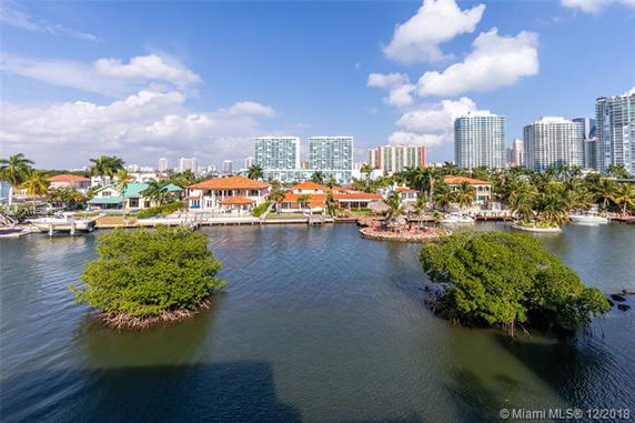 View of residential area with waterfront properties and distant high-rise buildings.