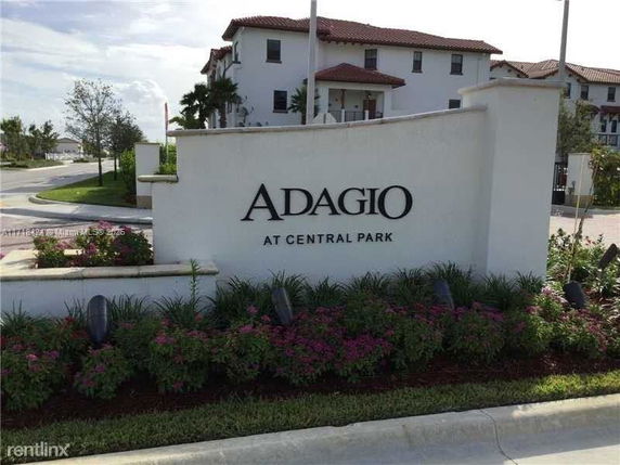 Front view of a residential building with a sign reading 'Adagio at Central Park.'