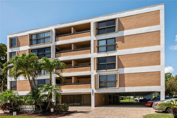 Front view of a multi-story apartment building with balconies.
