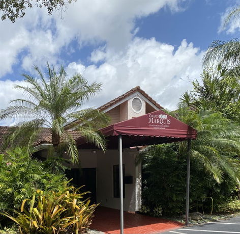 Front view of a house with a red canopy entrance.