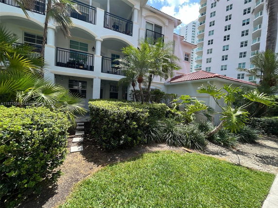 Front view of a multi-story residential building with balconies.
