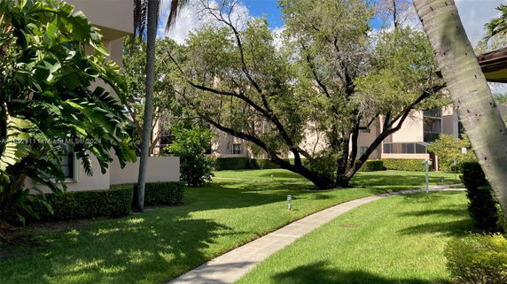 View of buildings surrounded by lush greenery and walkways.