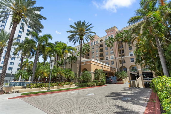 Front view of a multi-story residential building with arched entrances.