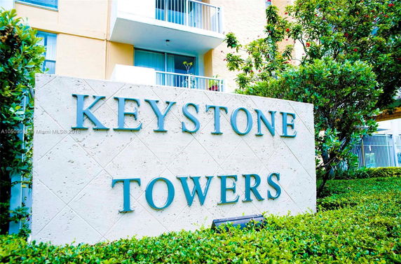 Front view of a building with the sign 'Keystone Towers'.
