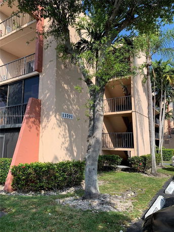 Front view of a multi-story apartment building with balconies.