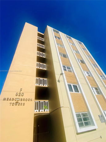 Front view of a multi-story building named Meadowbrook Towers.