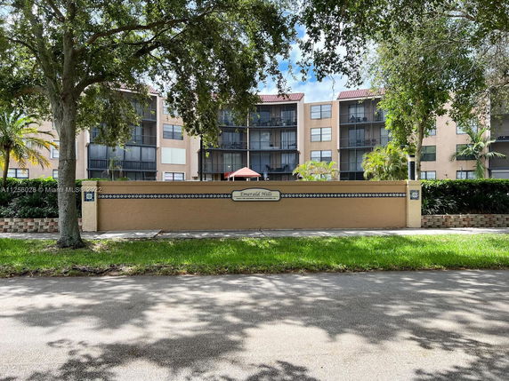 Front view of a residential building with multiple floors and balconies.