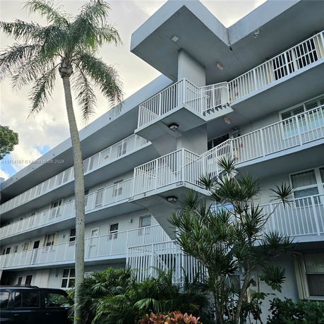 Front view of a multi-story residential building with balconies.