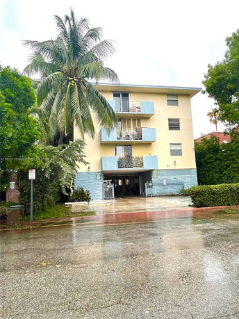 Front view of a multi-story residential building with balconies.