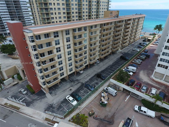 Front view of a multi-story apartment building with balconies.