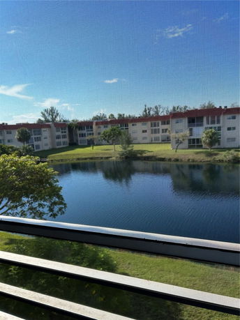 View of apartment buildings across a lake from a window.