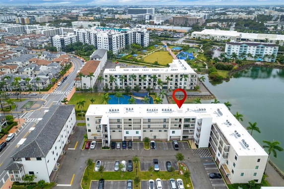 Aerial view of a residential area with multiple apartment buildings and a nearby body of water.