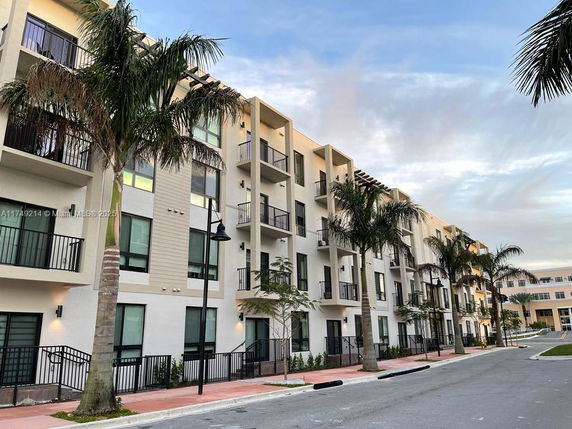 Front view of a multi-story residential building with balconies.