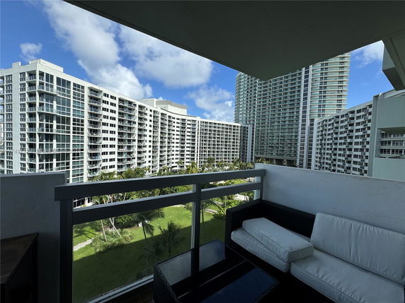 Outdoor view from a balcony overlooking multiple high-rise residential buildings.