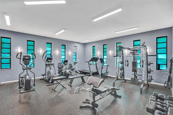 Gym area with various fitness equipment and weights.