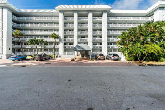 Front view of a multi-story building with a covered entrance.
