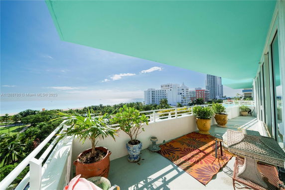Balcony view overlooking buildings and coastline.