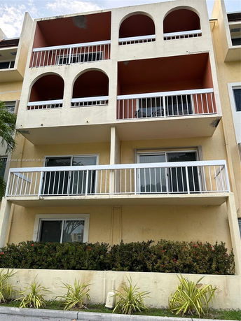 Front view of a multi-story building with balconies.