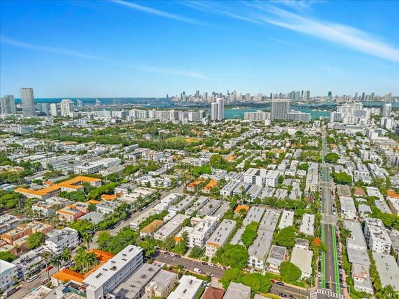 Wide angle view of a cityscape with numerous buildings and a distant skyline.