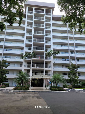 Front view of a multi-story residential building with balconies.