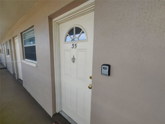 Front view of an apartment with a beige door marked number 35.