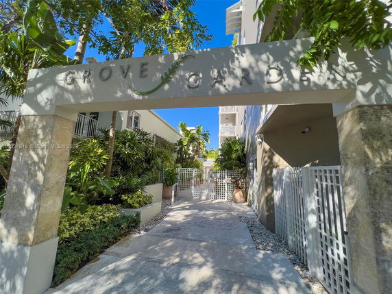 Entrance of a residential building with a sign reading 'Grove Garden'.