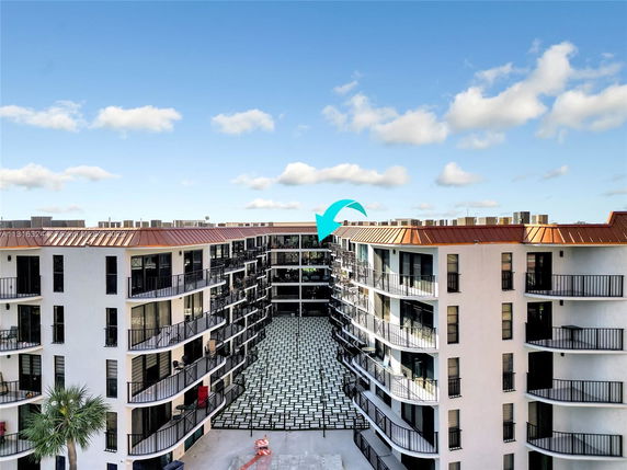 Front view of a multi-story apartment building with balconies.