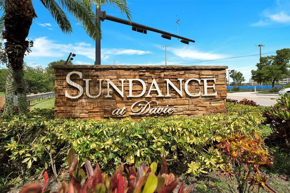 Stone monument sign with the text 'Sundance at Davie'.