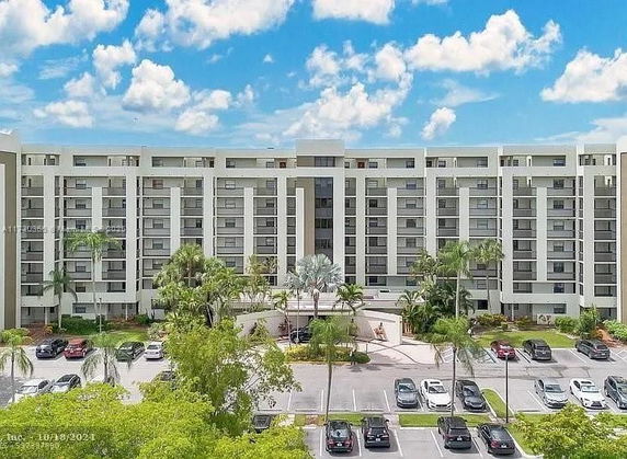 Front view of a multi-story residential building with multiple balconies.