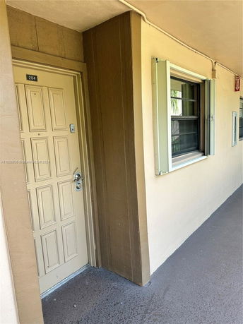 Entrance of a building with a door labeled 204 and adjacent window.