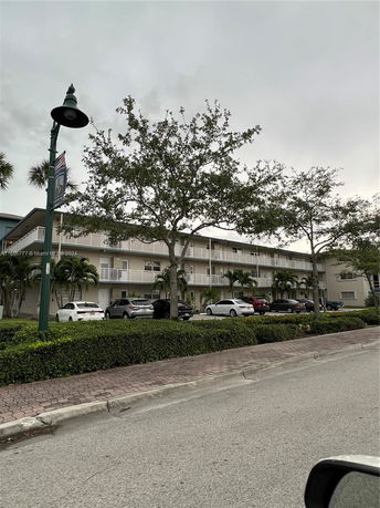 Front view of a multi-story residential building with balconies.