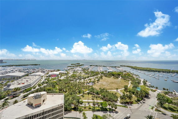 Aerial view of a coastal area with marinas and boats on the water.