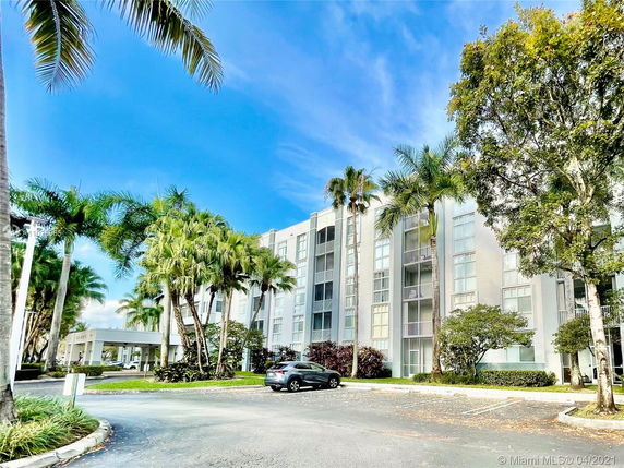 Front view of a multi-story residential building with balconies.