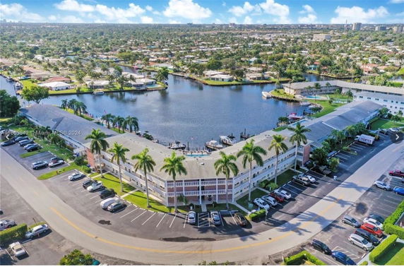 Panoramic view of a residential complex by a waterway.